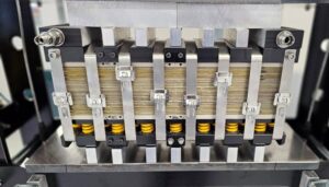 Stainless steel banding securing a fuel cell stack with uniform compression across multiple plates