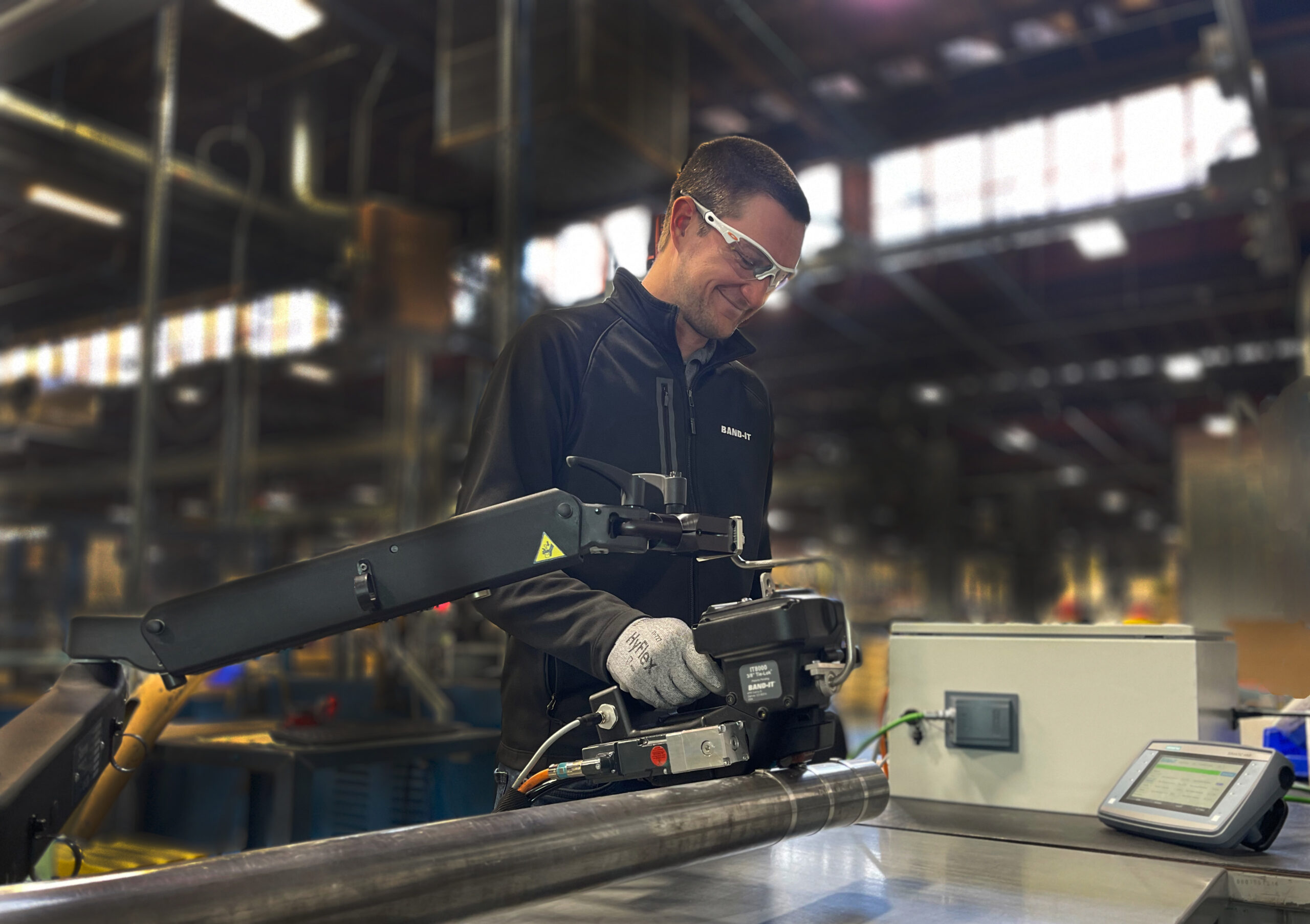 Sean operating a BAND-IT IT Series clamping tool in a production environment